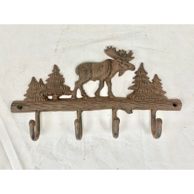 Fun metal moose hook. Perfect to hang keys, bath towels, robes, or coats on. Rustic cabin feel. This is a pre-owned item...