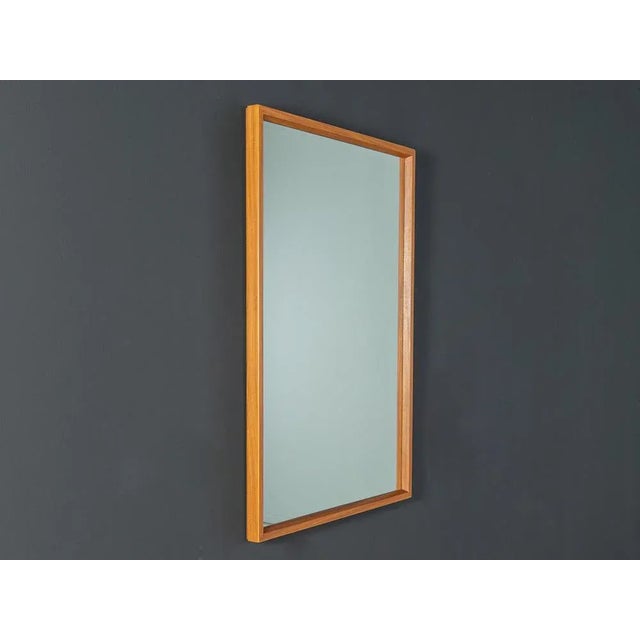 Classic mirror in Scandinavian design from the 1960s with high -quality solid wood frames in teak. Made in Denmark.