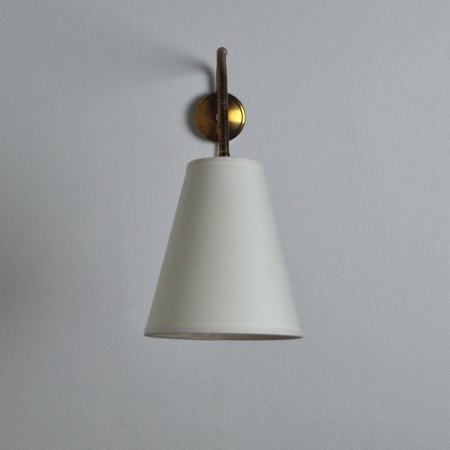 Scandinavian Modern Danish wall lamp with adjustable brass arm. Very good vintage condition with few signs of age and use....