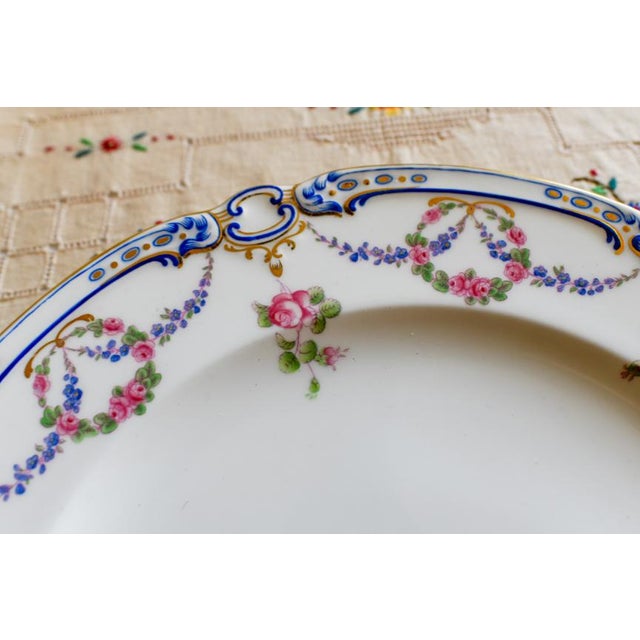 This is an antique and discontinued around 1898 Minton porcelain dinner plate in the "Roses, Pansies, and Forget-me-Nots"...