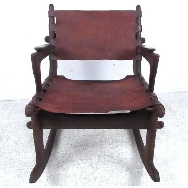 This unique vintage rocking chair features leather seat, unique dowel construction, and makes a stylish Primitive style...
