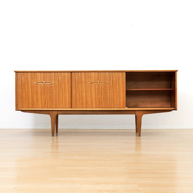 This vintage mid-century credenza was produced by Jentique Furniture during the 1960s. A wonderful minimalist design and...