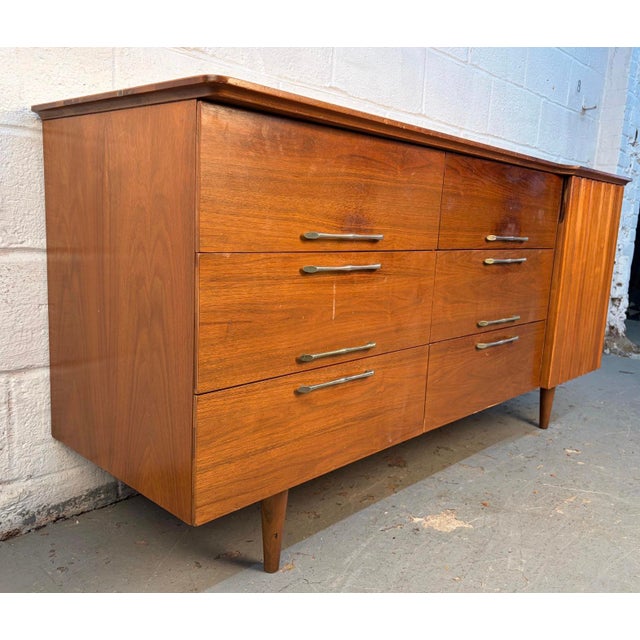 A classic mid-century modern lowboy dresser crafted from richly grained walnut by Young Manufacturing. Features clean...