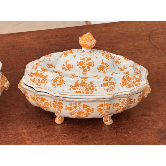 France; Moustiers-Sainte-Marie. Painted in monochrome orange-yellow with scattered flowers and sprigs in the so-called...