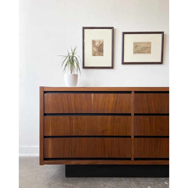 This gorgeous vintage 1970s Mid-Century Modern lowboy dresser by Lane Furniture Co. features a stunning rich walnut finish...