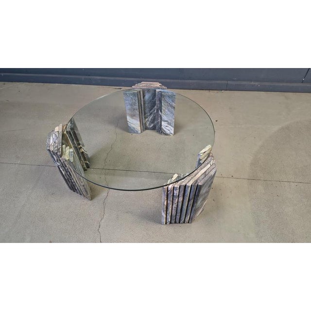 Timeless stepped marble base coffee table supporting a clear glass top. Beautifully veined marble bases. 1970s - Italy...
