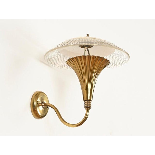 Stunning and unique pair of floral wall sconces with curved brass arms and marvelous mouth-blown murano glass shades....