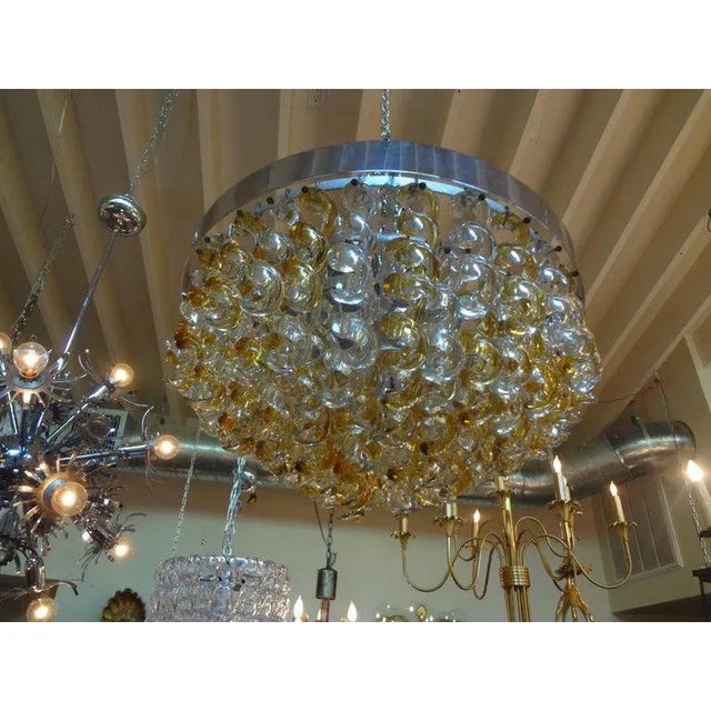 Unusual Hollywood Regency Murano chandelier by Mazzega, Italy. This stunning Mid-Century Modern Murano glass chandelier is...