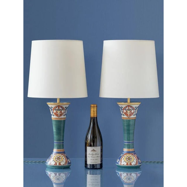 A pair of hand-painted Dutch art pottery lamps built on antique vases by the Arnhemsche Fayencefabriek of Arnhem,...