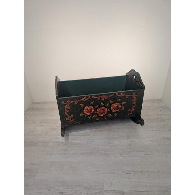 Hand-painted wooden cradle from the 1940s Hand-painted wooden cradle from the 1940s. It features beautiful, hand-decorated...