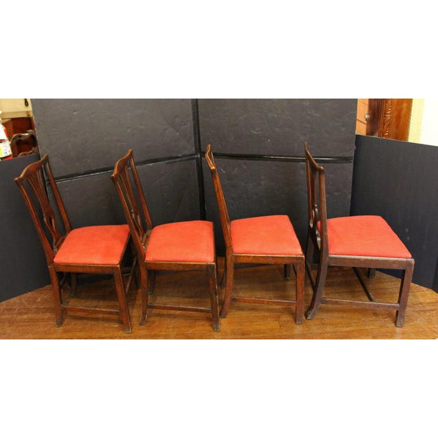 Circa 1770 Georgian set of 4 side chairs, English. Elm with slip seats. Serpentine crest rail over elegant shaped, pierced...