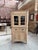 This rough-hewn elm corner cabinet, dating from the 1950s, has been fully restored. It consists of an upper section with...