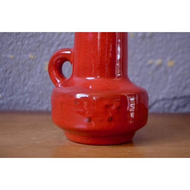 This pitcher with its sober shape and spotted red enamel is a pretty piece of ceramic. Its enamel is luminous, with a...