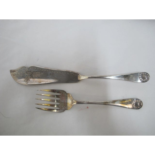 Antique Sheffield silver plate fish serving set in original case. Ornate floral and leaf design with shell design at...