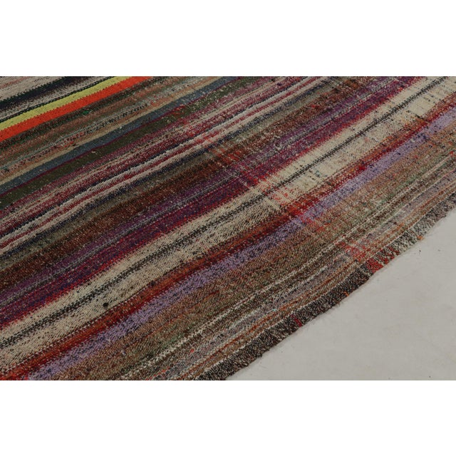 Handwoven in wool, a vintage Turkish kilim rug, connoting a rare variant of mid-century panel weaving styles circa...