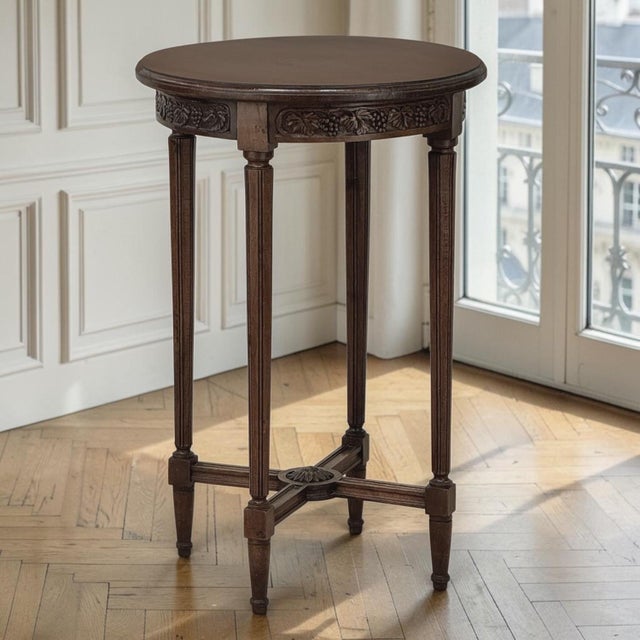 An elegant French Louis XVI style guéridon crafted from solid walnut, this diminutive round table has an exceptional...
