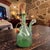 This Vintage Hand Blown Italian Green Glass Wine Decanter is a unique and handmade piece perfect for adding a touch of...
