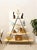 A striking open display shelf with an architectural A-frame silhouette, pairing warm natural wood shelves with a slender...
