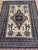 Afghan Turkmen geometric design rug, hand-knotted in Afghanistan from 100% wool. Measuring 6’8” x 9’10”, the rug features...