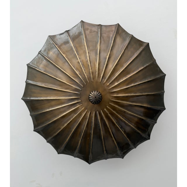 Bring timeless elegance to your home with this handcrafted solid brass flush mount ceiling light, inspired by sculptural...