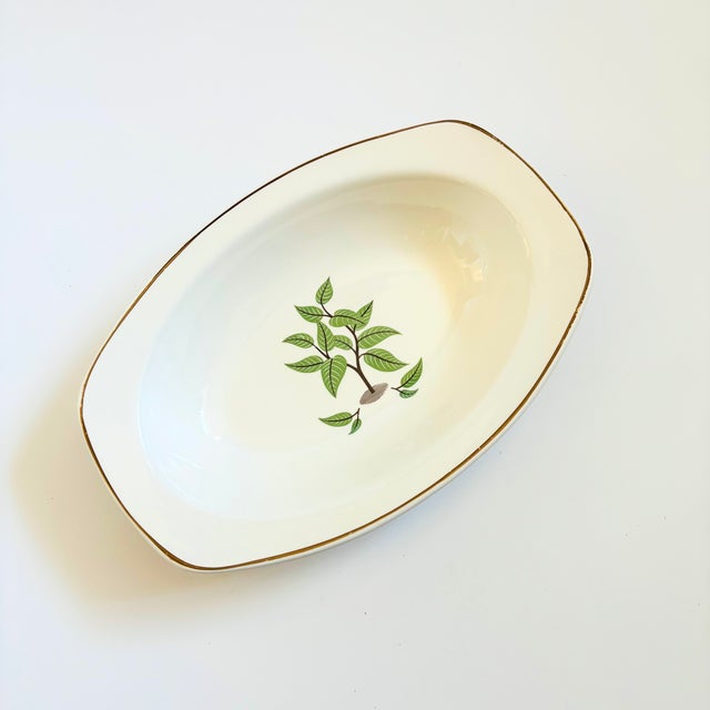 A vintage ceramic serving bowl produced by Taylor Smith Taylor from the "Conversation" series. Features a lovely coffee...