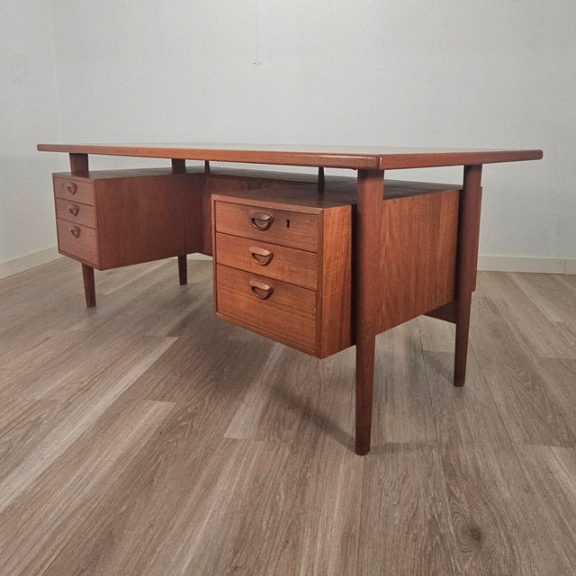 This executive floating desk is attributed to Kai Kristiansen and attributed to Feldballes Møbelfabrik, Denmark, dating to...