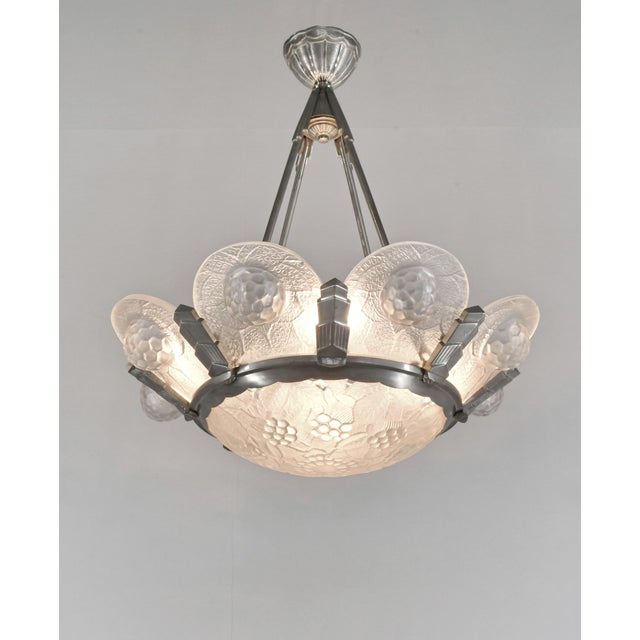Simonet frères A beautiful French 1925-1935 art deco chandelier in nickel plated solid brass or bronze holding nine shades...