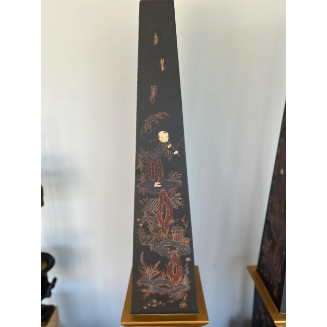 Italian, 20th century. Introducing a captivating pair of Vintage Chinoiserie & Partial Gilt Wood Decorated Obelisks, each...