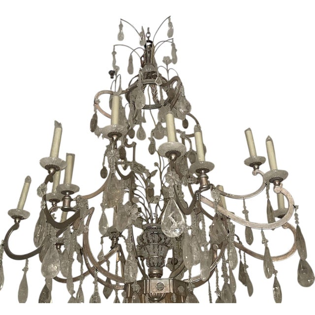 A spectacular large-scale Italian chandelier, crafted with a sculptural silver-leafed metal frame adorned with an...