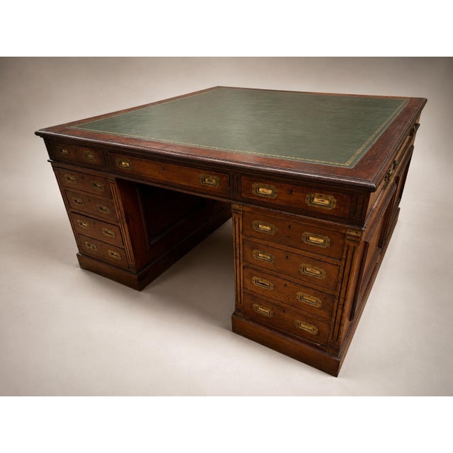 A commanding 19th century campaign partner’s desk in richly figured mahogany, conceived in the tradition of portable...