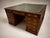 A commanding 19th century campaign partner’s desk in richly figured mahogany, conceived in the tradition of portable...