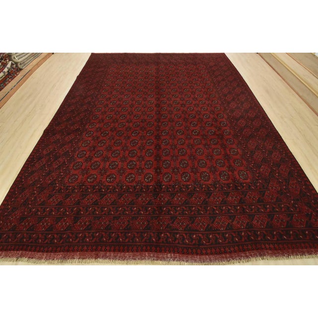 An authentic vintage tribal Turkmen rug hand-knotted with fine wool and natural dyes. This nomadic oriental rug features...