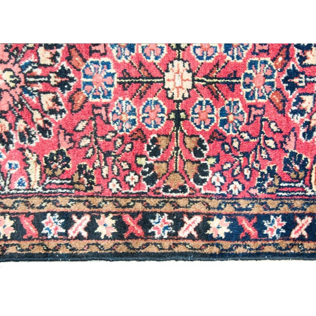 A charming petite early 20th century Persian Lilihan rug with a mirrored floral pattern with myriad floral clusters set...
