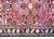 A charming petite early 20th century Persian Lilihan rug with a mirrored floral pattern with myriad floral clusters set...