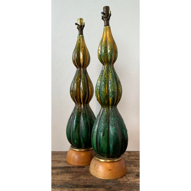 This exceptional pair of Mid-Century Modern table lamps showcases the bold, organic spirit of 1960s ceramic design....