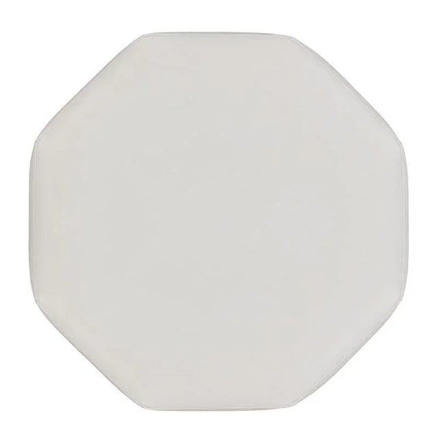 A wonderful ottoman with an octagonal upholstered top sits over eight side panels veneered with figured walnut.