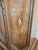 Renaissance Revival-style cabinet with a carved floral center panel, diamond inlay and an architectural two-part...