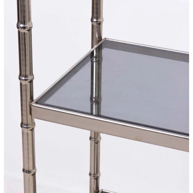 Chrome Hollywood Regency faux bamboo étagère with five gray glass shelves, circa 1970s. Please note of wear consistent...