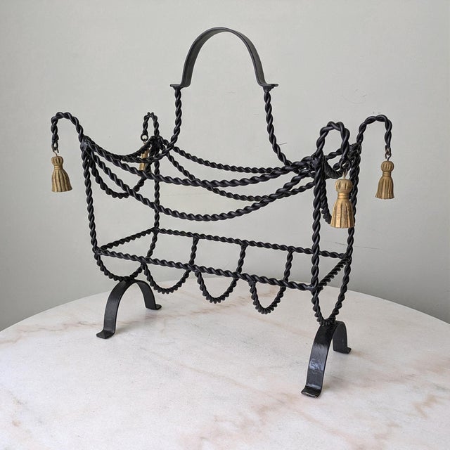 Vintage Hollywood Regency style floor-standing basket featuring twisted rope design and tassel accents.