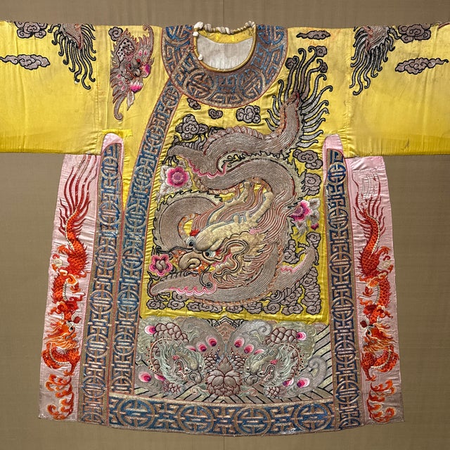 Design Plus Gallery presents a Framed Chinese Theater Dragon Robe from the Late 19th Century, Qing Dynasty. The robe is...