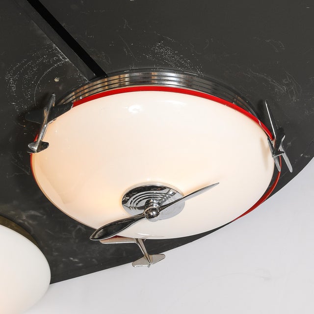 This extraordinary Art Deco Machine Age flush mount chandelier, designed by Moe Lights and crafted in America circa 1940,...