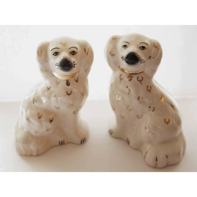 Pair of vintage Foo dogs. White glazed ceramic with black, red and gold accents.