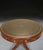 A smart regency mahogany fixed top drum table, the crossbanded edge with and intricately embossed inset green leather top,...