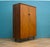 Mid-century wardrobe crafted in warm-toned wood with a clean, minimalist silhouette. Featuring beautifully grained doors,...