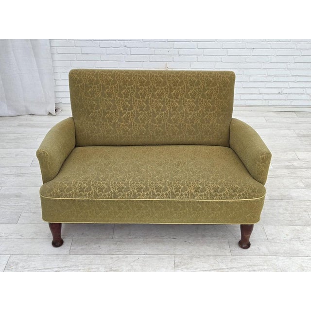 1950s, Danish 2-seater sofa. Green furniture wool fabric, brass springs in the seat, oak wood. Sofa was reupholstered by...