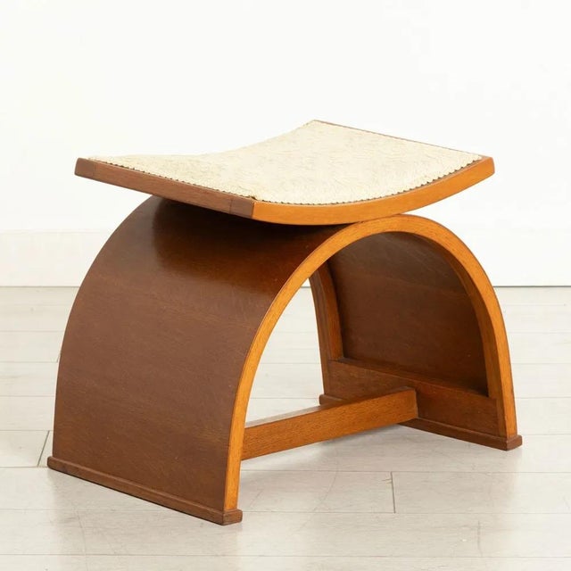 An art deco bedroom stool raised on an oak bentwood half circle with a central stretcher newly upholstered in an ivory...
