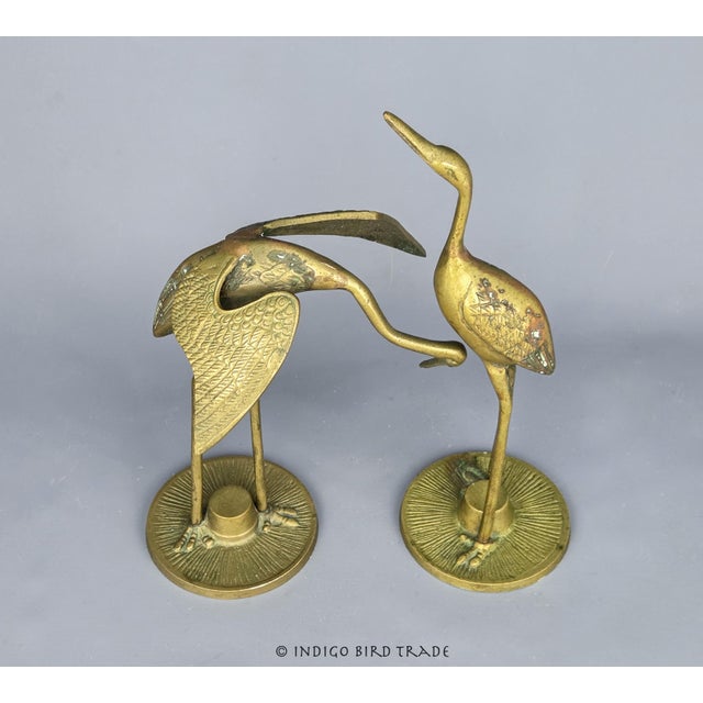 Pair of Vintage Bronze Crane Heron Statues These noble birds are crafted from bronze in classic mid-century style. Their...