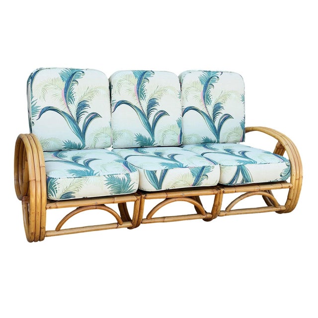 This beautifully restored Post War three strand, 3/4 round pretzel arm rattan section sofa for 3 people, features a rare...