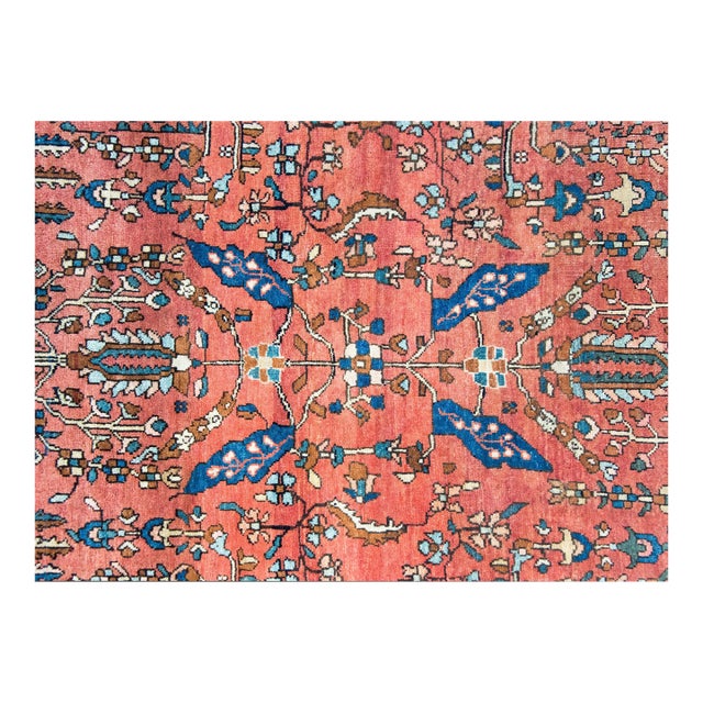 A stunning early 20th century Persian Sarouk Farahan rug with a chic mirrored floral and vine pattern set against an...