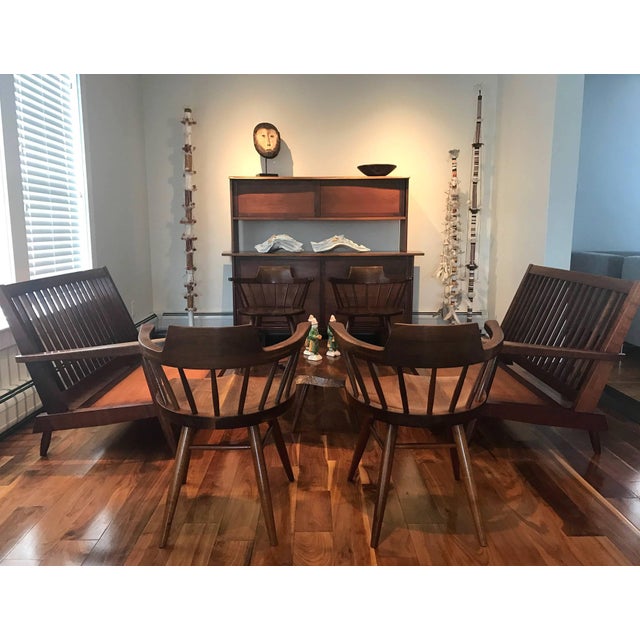 A wonderful set of four American black Walnut 'Captain" chairs handcrafted by George Nakashima in his New Hope Studio in...